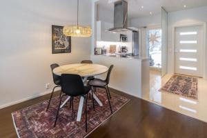 a kitchen and dining room with a table and chairs at Villa Ruudolf in Rovaniemi