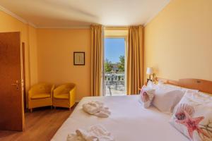 a hotel room with a bed with towels on it at Greif Hotel & Spa in Trieste +55 photos