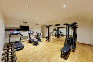a gym with treadmills and exercise equipment in a building at Greif Hotel & Spa in Trieste