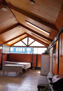 a large room with a table and benches in it at Hospedaje con Pensión Completa in Angol