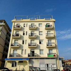 a tall building with balconies on the side of it at Hotel Seaview in Rimini