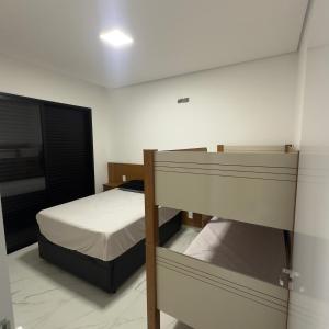 a bedroom with a bed and a bunk bed at Recanto dos Sonhos Ninho Verde 2 in Pardinho +23 photos