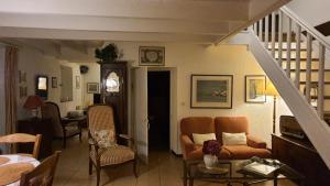 a living room with a couch and a staircase at QUIBERON Maison Le Manémeur Port Maria in Quiberon