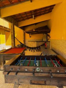 a large wooden chest with paddles in a room at Espaço Carvalhaes in Cabo Frio