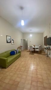 a living room with a green couch and a table at Casa Aver o Mar in Sirinhaém