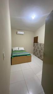 a small bedroom with a bed in a room at Casa Aver o Mar in Sirinhaém