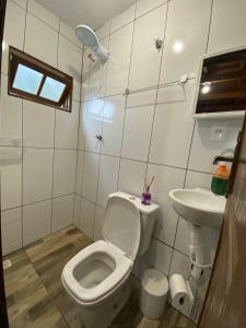 a small bathroom with a toilet and a sink at Chalé com jacuzzi Florianópolis in Florianópolis +15 photos