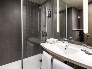 a bathroom with a sink and a shower at ibis London Greenwich in London +95 photos