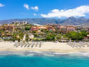 una vista aérea de una playa con sillas y edificios en Charming apartment with an excellent location, en Arona