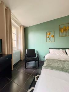 a bedroom with a bed and a chair in it at Le Perché in Melun