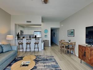 a living room with a couch and a table at Inn at Summerwinds #1403 in Navarre
