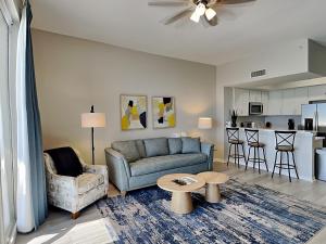 a living room with a couch and a table at Inn at Summerwinds #1403 in Navarre