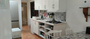 a white kitchen with a sink and a stove at Bett 2 im Frauen-2-Bettzimmer NUR Frauen Only Women SOLO Mucheres in Mogán