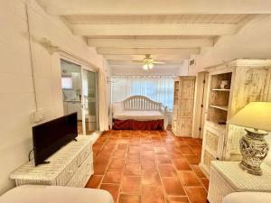 a living room with a couch and a bed at Baked and Barefoot Beach Bunglows in St. George Island