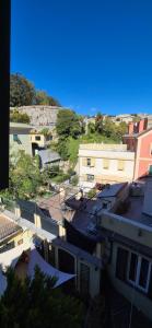 a view of a city with buildings and trees at San Vincenzo B in Genoa