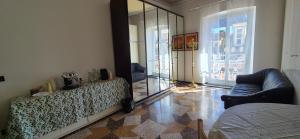 a living room with a mirror and a couch at San Vincenzo B in Genoa