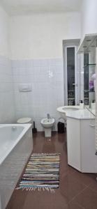 a bathroom with a tub and a toilet and a sink at San Vincenzo B in Genoa