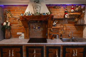 a kitchen with a sink and a brick wall at AMA house in Alba Iulia +23 photos