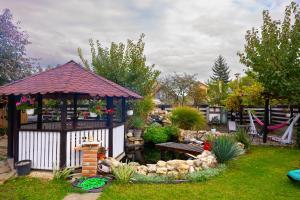 a garden with a gazebo and a pond at AMA house in Alba Iulia