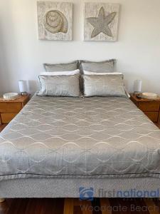 a bedroom with a bed with two pillows at 4/139 The Esplanade in Woodgate +5 photos