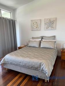 a bedroom with a large bed and a window at 4/139 The Esplanade in Woodgate