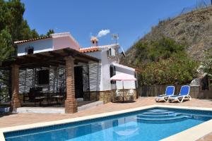 a villa with a swimming pool and a house at Finca La Jara with private Pool in Cómpeta