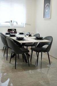 a dining room table with chairs and wine glasses at Les suites du lion in Rosheim