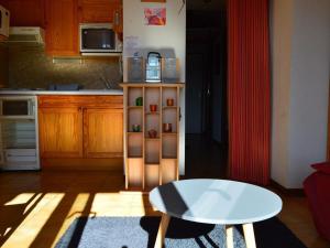 a kitchen with a table and a table in a room at Appartement calme centre station avec parking - FR-1-593-41 in Les Angles