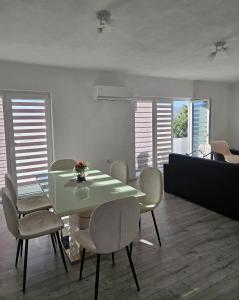a dining room with a green table and chairs at Villa Milla in Veles
