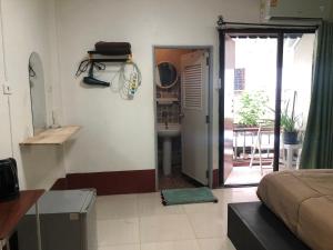 a bedroom with a bed and a door to a bathroom at Lucky Guest House in Phi Phi Don