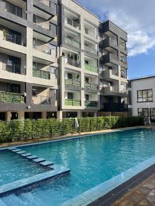 einem Pool vor einem Apartmentgebäude in der Unterkunft El luxe Homes Muthiga in Kiambu