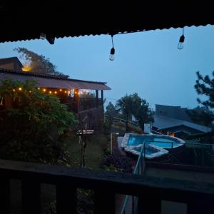 a view of a backyard at night with a pool at Hacienda Mi Montañita in Los Altos de Cerro Azul