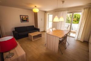 a living room with a couch and a table at Apartments Gardelin Superior in Zadar