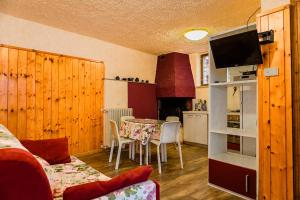 a living room with a table and a kitchen at Holiday Mantovani in Brenzone sul Garda