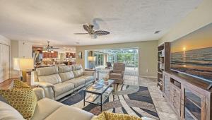 a living room with a couch and a tv at Gulf Birdie - 5551 in Siesta Key