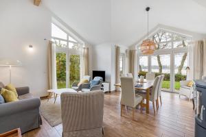 a living room with a couch and chairs and a table at Rosenuferhaus in Hestoft