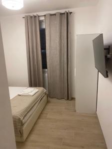 a small bedroom with a bed and a television at B&B La Fenice in Chieti