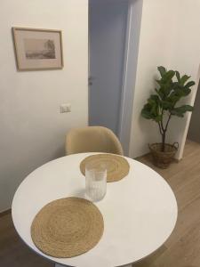 a white table with a glass and a chair at B&B La Fenice in Chieti