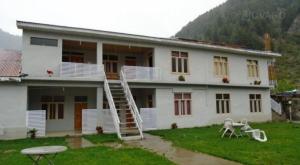 a house with a ladder in front of it at Naran Mountain Chalets in Dargai