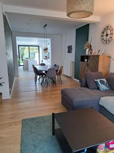 a living room with a couch and a table at Grande maison familiale à Theux in Theux