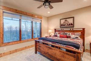 a bedroom with a bed and a large window at Happy Trails at Eagles Nest in Elk Park