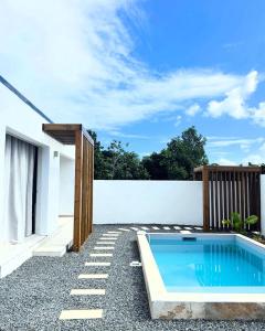 a swimming pool in the backyard of a house at Oasis in Petit-Bourg