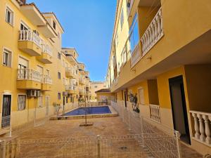 an empty courtyard of a building with a swimming pool at Piso Romántico con piscina in Formentera de Segura