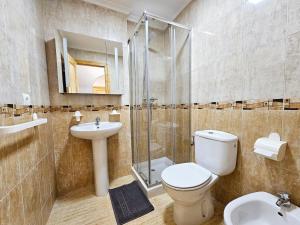 a bathroom with a toilet and a sink and a shower at Piso Romántico con piscina in Formentera de Segura +25 photos
