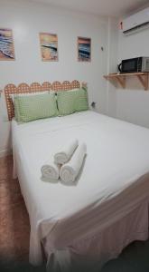 a large white bed with two towels on it at MA Prime Stay in Natal +24 photos