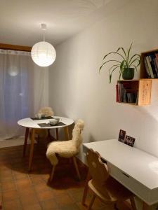 a dining room with a table and a chair with a stuffed animal at Chesa Muntanaia in Pontresina