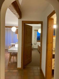 an open door to a dining room with a table at Chesa Muntanaia in Pontresina