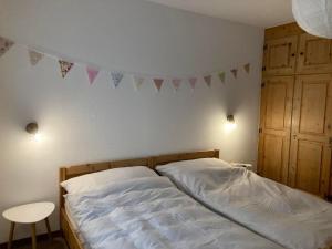 a bedroom with a bed with flags on the wall at Chesa Muntanaia in Pontresina +9 photos
