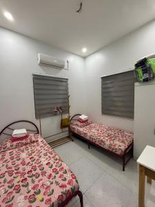 a room with two beds in a room at Aufa House in Padang Rengas +1 photo