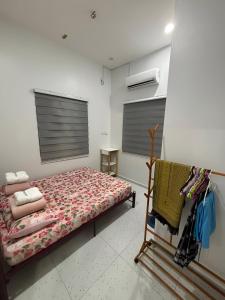 a bedroom with a bed in a room at Aufa House in Padang Rengas
